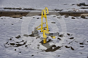 Empty Ride-On Sandbox Digger on children`s playground under the snow.   Burnaby BC Canada