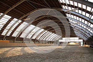 Empty riding hall building interior without people ready for equestrian training wintertime
