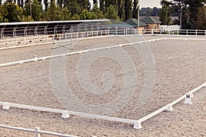 Empty riding sand arena of a horse farm. Concept of sport, competition