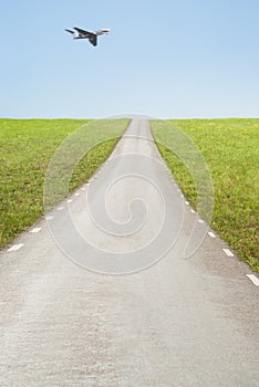 Empty road and airplane in the sky