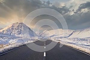 Empty road blank horizon dramatic winter snow at sides in Scottish highlands at Glencoe Rannoch Moor Buachaille Etive Mor Mountain