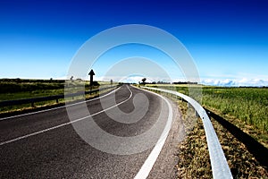 An empty road in the campaigns with a blue sky