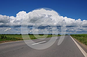 Empty road with clouds above