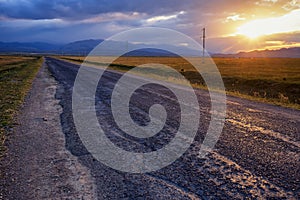 Empty road, clouds and sunset