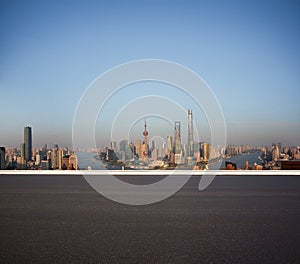 Empty road floor surface with city landmark buildings at Shanghai Skyline