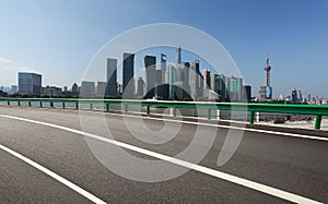 Empty road floor surface with modern city landmark buildings in