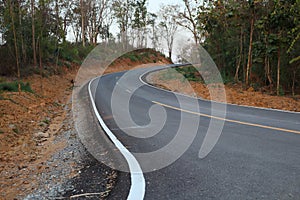 Empty road, hills in the forest through the green trees Photos outside Uttaradit City,