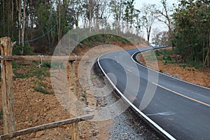 Empty road, hills in the forest through the green trees Photos outside Uttaradit City,