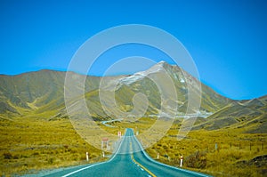 Empty road leading through scenic countryside, New Zealand