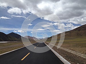 a empty road in the middle of a vast plain area