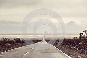 Empty Road With Mountain Silhouettes 