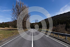 Empty road, mountains and sky at