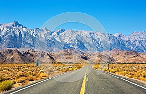 Empty road near Lone Pine with rocks of the Alabama Hills and the Sierra Nevada in the background, Inyo County, California, United