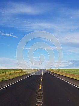 Empty road in the prairies, lonely road.