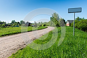 Empty road with sign for village name