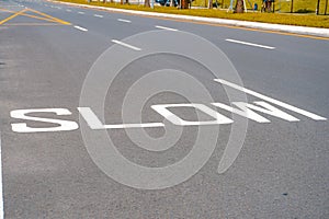 Empty road with slow down text