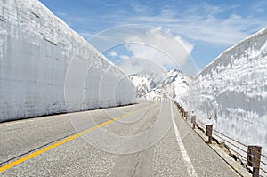 Empty road and snow wall at japan alps tateyama kurobe alpine