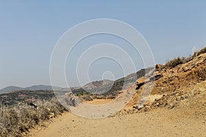 Empty road in southern Morocco with mountains in the background