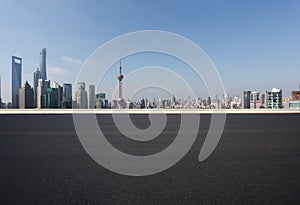 Empty road surface floor with city landmark buildings of Shanghai Skyline