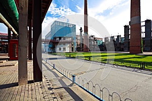 Empty road surface floor with old steel steelworks of pipelines