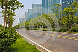 Empty road surface with modern city buildings background