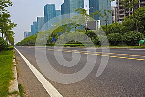 Empty road surface with modern city buildings background