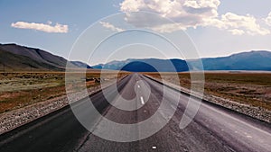 Empty road among the valley on a background of mountains