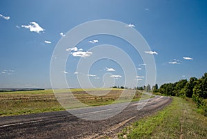 Empty road with a view of agricultural fields