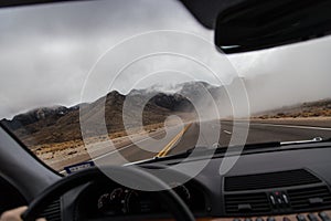 Empty roadway through car window