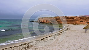 Empty rocky cape with sandy beach near beautiful sea