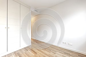 Empty room with built-in wardrobe and ducted photo