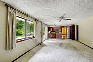 Empty room with carpet floor connected to kitchen