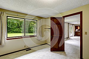 Empty room with carpet floor and opened door