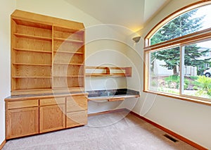 Empty room interior with beige carpet, cabinet and large window.