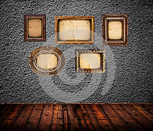 Empty room interior with black wall and vintage photo frames