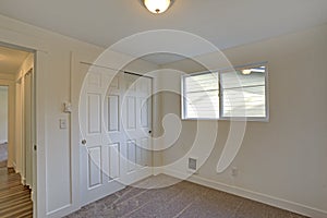 Empty room interior with built in closet and carpet floor.