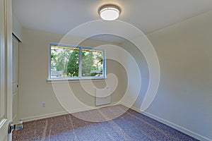 Empty room interior with milky walls and carpet floor.