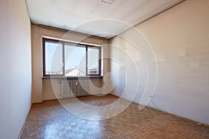 Empty room interior with wooden floor, dirty walls