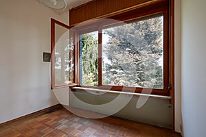 Empty room interior with wooden floor and large open window