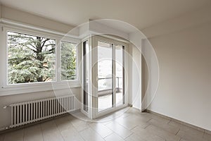 Empty room, large windows overlooking nature