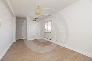 Empty room with light wood flooring, freshly painted plain white walls