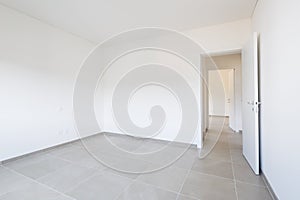 Empty room in a modern apartment with white walls, nobody in the scene