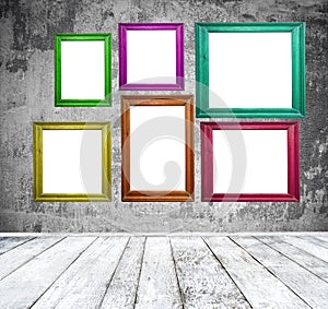 Empty room with multicolored photo frames