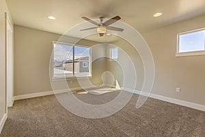 Empty room of a new house with beige wall paint and carpeted floor