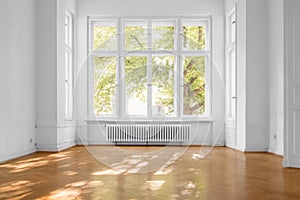 Empty room in old apartment building with  parquet floor and big