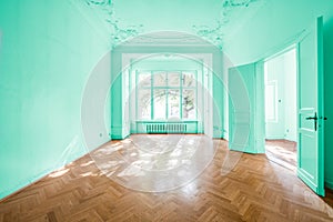 Empty room in old apartment building with wooden parquet floor -