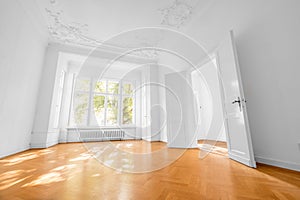 Empty room in old apartment building with wooden parquet floor -