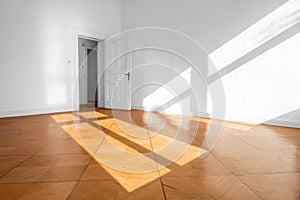 Empty room in old apartment building with wooden parquet floor -