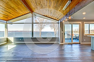 Empty room with planked vaulted ceiling photo