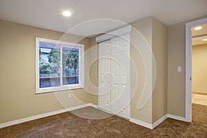 Empty room, sand beige walls, carpet floor in a luxury home.